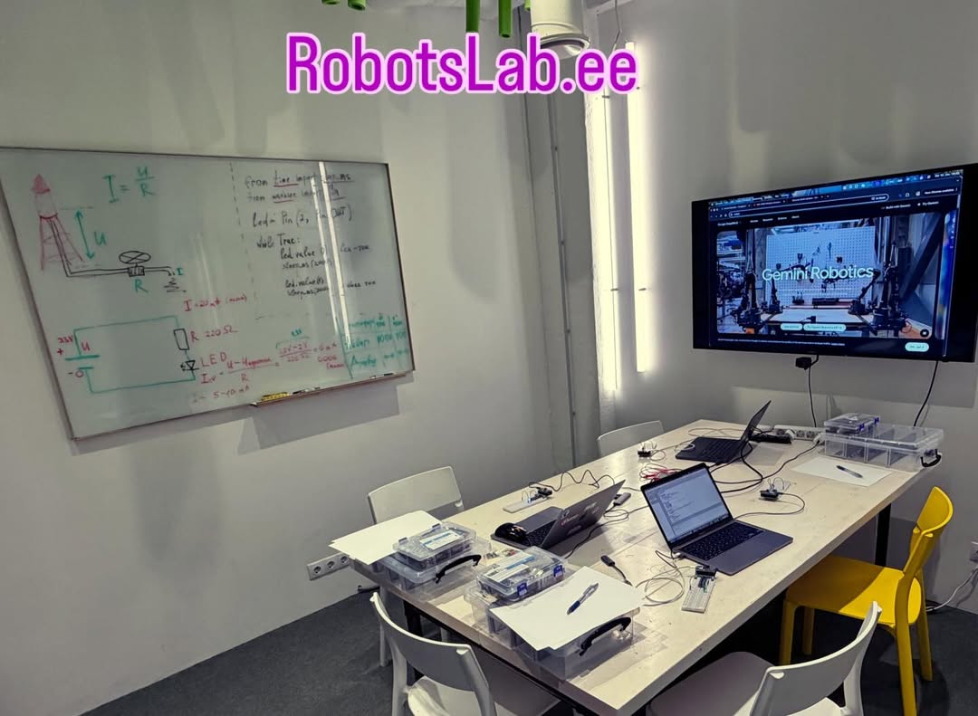 RobotsLab classroom in Tallinn — whiteboard and electronics workstations